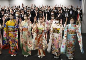 People cheer at a ceremony at the Nagoya Stock Exchange